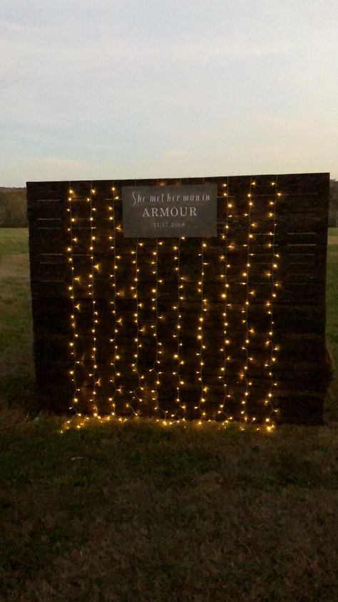 Photo Backdrop for wedding.  Hand made of pallet wood and installed twinkling lights Lights Photo Backdrop, Wood Pallet Photo Backdrop, Pallet Picture Backdrop, Pallet Backdrop Birthday, Homecoming Backdrops For Pictures, Grad Party Picture Backdrop, Pallet Photo Backdrop, Pallet Picture Display, Wedding Picture Walls