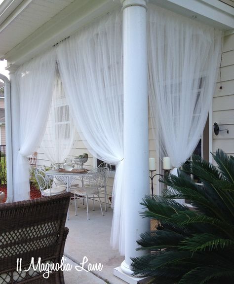 Inexpensive sheer curtain panels from Ikea (Lill) are used to create a "screened" porch from a covered porch.  Read the how-to's at 11 Magnolia Lane. Diy Screened Porch, Small Outdoor Table, Screened In Porch Diy, Small Pergola, Porch Curtains, Rental Decorating, Diy Deck, House With Porch, Diy Pergola