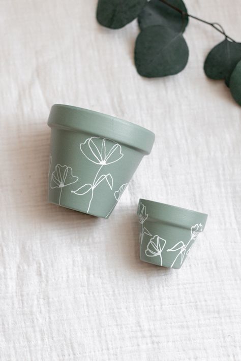 Beautiful sage carefully hand painted with love - perfect for your plant’s new home #handpainted #terracotta #indoorplantsdecor Diy Paint Planter Pot, Simple Plant Pot Painting, Mini Plant Pot Painting, Painted Cement Pots, Painted Herb Pots, Decorating Pots For Plants, Teracota Pot Painting Ideas, Simple Painted Pots, Plant Pot Designs Paint