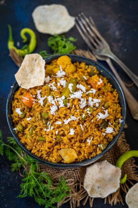 Spicy and packed with delicious flavors, Maharashtrian Masale Bhat is the perfect comfort food that comes together in under 30 minutes. Make this traditional one-pot, vegan dish using a medley of vegetables and a hot spice mix - Goda Masala. Maharashtrian Recipes, Indian Rice Recipes, Hot Spices, Naan Recipe, Rice Varieties, Rice Side Dishes, Spice Mix, Yummy Comfort Food, Indian Spices