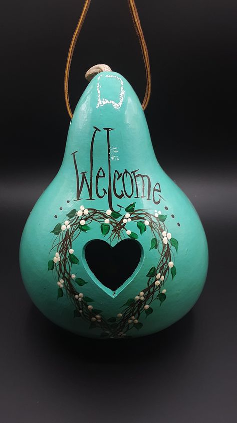 Hand painted gourd birdhouse, meant to hang outside for the birds to nest in, and use for shelter.  All hand painted and signed by the artist. This particular gourd is painted with acrylic paints, teal color for the background, and a twig heart design around the hole with the word "Welcome" above it. Gourd Birdhouse Ideas Painting Patterns, Painted Gourds Birdhouses, Birdhouse Gourds Ideas, Thunder Gourds, Gourd Bird Houses, Painting Gourds, Gourd Projects, Dried Gourds, Birdhouse Gourds