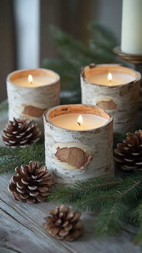 Three birch bark candles, pine cones, and evergreen leaves create a cozy, rustic winter scene on a farmhouse table. Woodsy Farmhouse, Primitive Winter Decor, Candle Centerpieces Elegant, Rustic Candle Centerpieces, Winter Decor After Christmas, Rustic Christmas Decor Ideas, Decor After Christmas, Birch Candles, Woodland Tree