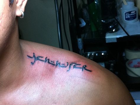 Jennifer name tattoo design on upper shoulder for man Shoulder Name Tattoo Men, Jennifer Tattoo Name, Name On Shoulder Tattoo, Tattoo Top Of Shoulder, Top Of Shoulder Tattoo Men, Upper Shoulder Tattoo Men, Upper Shoulder Tattoo Men Ideas, Shoulder Name Tattoo, Shoulder Tattoo Men