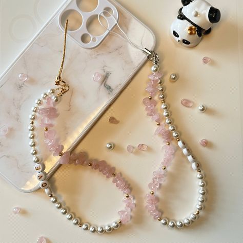 Length: around 17 CM Elevate your phone's style with this personalised phone charm, featuring natural rose quartz crystals and crystal glass pearls. Handmade with love, each charm is unique and customisable with your choice of initials or name. The soothing rose quartz and elegant pearls make it both beautiful and meaningful. It's perfect for adding a personal touch and keeping your phone secure. This charm also makes a thoughtful and personalised gift for loved ones. Customize your phone charm today and carry a piece of personalised elegance with you! Pearl Phone Charm, Beaded Designs, Red Quartz, Mask Chain, Phone Charms, Boho Chic Jewelry, Bracelets Diy, Eye Glass, Phone Strap