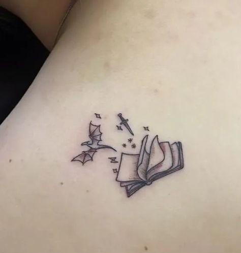 Book With Wings Tattoo, Unique Fantasy Tattoos, Tattoo Ideas Fandom, Minimalist Throne Of Glass Tattoo, In Memory Best Friend Tattoos, Tattoos For Fantasy Book Lovers, Sister Tattoos Books, Tattoo Ideas Fantasy Art, Booktok Inspired Tattoos