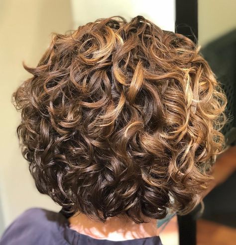 Short Curly Golden Bronde Hairstyle Short Curly Haircuts For Women Over 50 Round Faces, Short Curly Hairstyles Blonde, Naturally Curly Bob Haircut, Layered Short Bob Hairstyles, Stacked Curly Bob Haircut, Permed Bob Hairstyles, Chin Length Curly Hair, Curly Bobs For Older Women, Short Curly Hair With Layers