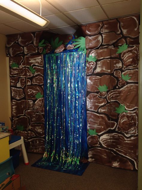 Classroom waterfall for rainforest theme Rainforest Classroom Transformation, Classroom Waterfall, Rainforest Theme Party, Rainforest Classroom, Jungle Rainforest, Preschool Jungle, Rainforest Project, Forest Classroom, Jungle Classroom