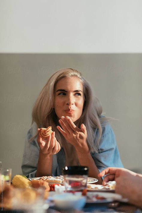 Portrait of a beautiful blond girl eating at a dinner party People Eating Dessert Photography, Cooking Photoshoot Aesthetic, Family Dining Photography, People With Food Photography, People Sharing Food Photography, Happy Lifestyle Photography, Dinner Party Editorial, Friends Dinner Party Food, Food Photography With Model