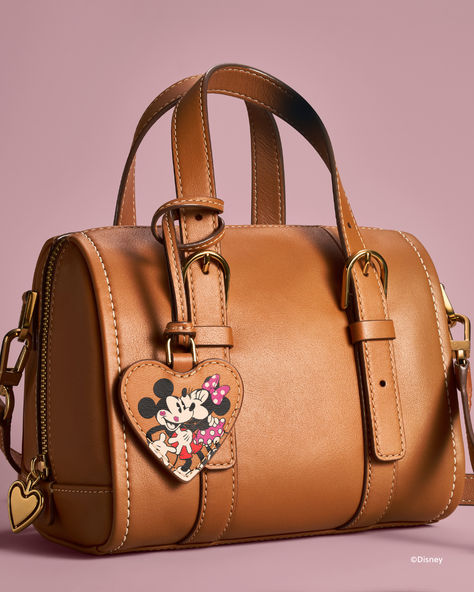 Find the wonder in every moment with the Disney Fossil collection. This special-edition mini satchel features one slide pocket, one zipper pocket, an adjustable and detachable crossbody strap with two handles, brown leather with contrast stitching and Disney's Mickey Mouse and Minnie Mouse. The perfect Valentine's Day gift for the ultimate Disney fan! Fossil Collection, Mickey Mouse Purse, Cozy Things, Mickey Mouse And Minnie Mouse, Disney Purse, Disney Day, Disney Fan, Disney Stuff, Disney Accessories