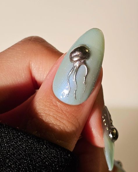 little jellyfish buddies keeping me company while I try to make more 3d miniatures 😊🪼 Ft. @orly Morning Dew* @gelcare.official Patent Leather Black, Top Coat @sweetienailsupply @jinb_korea Crazy Top Coat Thick @aimeiligelpolish Silver chrome powder *PR • Gifted Product • No Obligation to Post* #jellyfish #chromenails #silverchrome #dew #turquoise #gelnailart #pressonnails #3dnailart jellyfish. 3d textured nails art. summer nails. ocean inspired. miniature nail gel art. mirror chrome. Jelly Fish Make Up, Summer Nails Ocean, Nails With Jellyfish, Jellyfish Acrylic Nails, Jellyfish Inspired Nails, Jellyfish Inspired Makeup, Nail Gel Art, Ocean Inspired Nails, Korea Nails