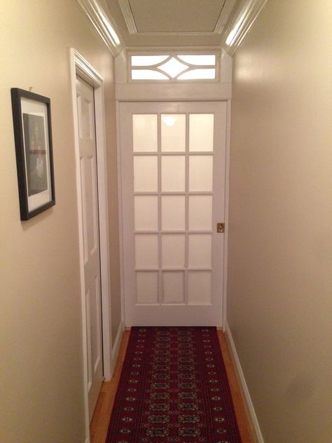 Frosted glass pocket door and transom bisects long hallway and adds privacy to master bedroom suite. Hallway Privacy Door, Bedroom Door With Glass Panels, Add Door To Hallway, Pocket Door Hallway, Door To Close Off Hallway, Door For Hallway, Dining Room Conversion, Corridor Door, Pocket French Doors