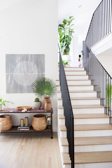 Traditional Home Bohemian Remodel Inspiration | Apartment Therapy 1980s Home Remodel, Wood Shingle Siding, Wrought Iron Banister, Banister Remodel, Boho Style Furniture, 1980s Home, Exposed Rafters, Remodel Inspiration, Entrance Foyer