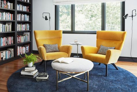 Crisp white walls, a bold blue rug, and mid-century modern mustard yellow chairs create a well-rounded look in this home's relaxed sitting area. Mid Century Modern Furniture Redo, Yellow Chairs, Yellow Chair, Yellow Room, White Marble Countertops, Furniture Redo, Decoration Inspiration, Mid Century Modern House, Mid Century Modern Furniture