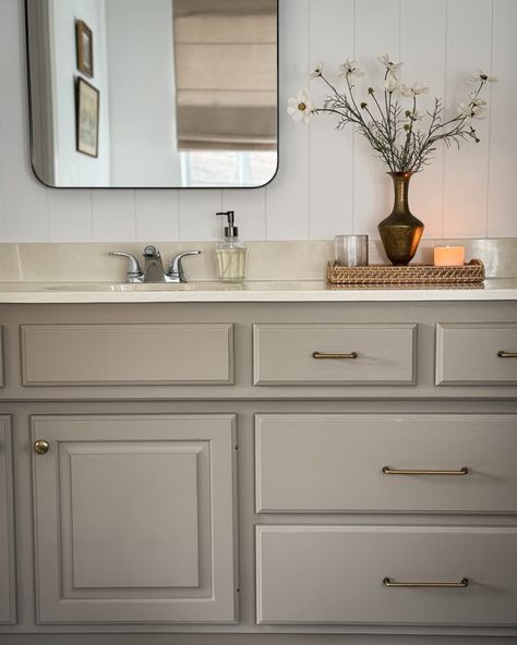 Bathrooms With Cream Countertops, Tan Vanity Bathroom Ideas, Ivory Bathroom Cabinets, Taupe Painted Bathroom Cabinets, What Color To Paint Bathroom Cabinets, Ivory Countertops Bathroom, Painted Bathroom Cabinet Colors Master Bath, Bathroom Tan Vanity, Beige Bathroom Fixtures