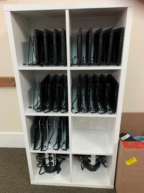 IKEA bookcase, file holders and cable tie downs. Classroom Ipad Storage Ideas, Classroom Device Storage, Multiple Laptop Storage Ideas, Classroom Laptop Organization, Classroom Ipad Charging Station, Classroom Computer Storage, Chromebook Organization In The Classroom, Classroom Laptop Storage, Chromebook Storage Classroom