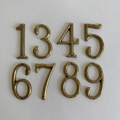 SOLD PER NUMBER Numbers Available: 7 Vintage brass house numbers with original patina present on each number.  The level of patina/ finish does vary from number to number.  Exact date of production unknown. Mid to Late 20th Century. Markings: - No markings present Condition: - Original vintage condition with wear appropriate for age - In untouched state -- brass has not been polished - Level of patina/ finish does vary from number to number - Original patina present on each number Measurements: - Height - between 2 3/4"to 3" inches tall - Width - approx. 1 1/2" inches wide Shipping: - Item will ship within 1-3 business days - Item will ship via USPS Ground Advantage, UPS Ground, or UPS Ground Saver - Shipping Upgrade Option: USPS Priority Mail for an additional fee of $15.00 for the first Brass House Numbers, Address Signs, Spartanburg Sc, Virginia Homes, Patina Finish, Lara Croft, Humble Abode, House Number, House Address