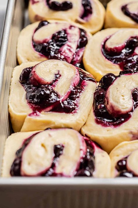 side view of blueberry rolls. Triple Berry Cinnamon Rolls, Blueberry Sourdough Cinnamon Rolls, Blueberry Cream Cheese Sweet Rolls, Blueberry Cinnamon Roll Bake, Blackberry Sweet Rolls, Spring Cinnamon Rolls, Blueberry Lemon Cinnamon Rolls, Lemon Blueberry Cinnamon Rolls, Blueberry Rolls With Cream Cheese