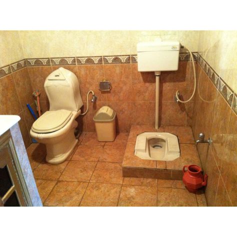 Two toilets in a middle-class Pakistani home, 2012.  One commode and one Persian-style squat toilet. Red pitcher on right is for washing oneself.  On left the commode has a sprayer. Pakistani Bathroom Designs, Commode Toilet Design, Indian Toilet Design, Indian Bathroom Interior Design, Indian Toilet, Class Bathroom, Latest Bathroom Tiles Design, Latest Bathroom Tiles, Squat Toilet