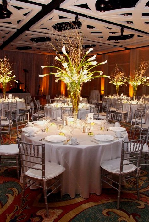 One piece of decor that stood out in Lauren and Chris's reception was the centerpiece design. The Ritz-Carlton, Naples arranged tall displays of white calla lilies, curly willow tips and white stock flowers that glowed. With simple silver linens and matching chiavari chairs, the centerpieces were sure to grab attention. Calla Lily Wedding Centerpiece, Calla Lily Centerpiece, Calla Lily Centerpieces, Lily Wedding Invitations, Lily Centerpieces, Stock Flowers, White Centerpieces, Calla Lily Wedding, White Centerpiece