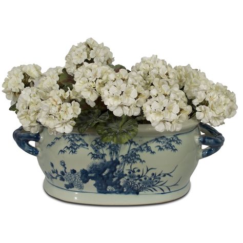 Featuring handpainted bird and flower motifs throughout, this classic blue and white porcelain footbath planter is a work of art worth collecting. The planter features paintings of four Chinese flowers, plums, chrysanthemums, peonies, and bamboo trees on its front and back. Two matching blue handles in a braided style complete the overall design. The spacious interior basin, measuring 13"W x 8"D x 6"H, is the perfect home for any medium-sized house plant or as the base for your floral arrangemen Footbath Planter, Chinese Flowers, Rectangle Planters, Bird And Flower, Bamboo Tree, Flower Motifs, Red Lantern, Willow Pattern, Blue Garden