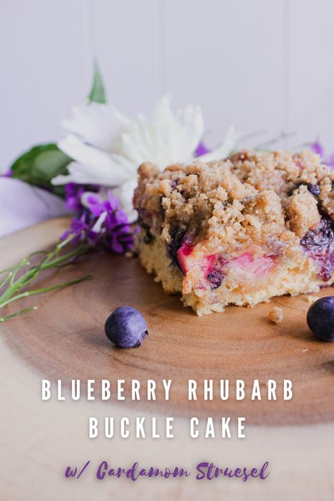 Slice of blueberry rhubarb buckle cake with flowers and stray blueberries. Dutch Oven Chicken Noodle Soup, Rhubarb Buckle, Pumpkin Sticky Buns, Buckle Cake, Beef Birria, Rhubarb Coffee Cakes, Blueberry Rhubarb, Bbq Party Food, Dutch Oven Chicken