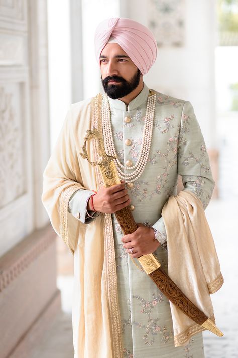 Here's real groom Raj wearing his soft mint green sherwani on his wedding day at Gravesend Gurdwara. His pink turban from Bespoke Turbans (UK) adds to the contemporary look. Mens Wedding Sherwani Indian, Achkan For Men Indian Weddings Punjabi, Dulha Sherwani Wedding For Men, Sikh Groom Outfit Sherwani, Pink Sherwani For Groom, Wedding Sherwani For Groom Latest, Hindu Wedding Outfit, Traditional Pista Green Sherwani With Drape, Pastel Green Sherwani Groom