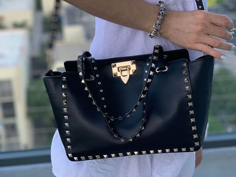 Story time! When I purchased the Valentino Small Rockstud Bag in Black Smooth Calfskin in Italy this past spring, I carefully boxed it up inside my suitcase before embarking on the trip back to Miami. To my horror, when I began unpacking at home, I realized one of my unbranded (less than $50) leather travel … Valentino Rockstud Bag Outfit, Valentino Rockstud Bag, Valentino Bag, Soft Leather Tote, Gucci Boots, Valentino Garavani Bag, Dream Bags, Cheap Purses, Lady Bags