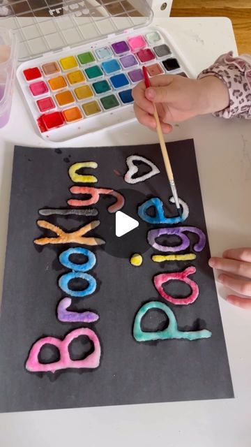 Brittany Bacharach on Instagram: "If you haven’t tried salt painting yet, save this to try!   On a piece of paper, use washable glue to write your child’s name. Pour table salt on top and shake off excess. Then paint your name by tapping a paintbrush in water and watercolor paint and then tapping the salt covered glue letters! It’s so simple, yet so fun. The end result is always so pretty too.   This isn’t an art project that can be hung up after- salt will fall. It’s more about the process and we like to enjoy it on the countertop for a bit!   Save this to try and follow for more ideas!  @stayathomeactivitymom   #kidsartideas #preschoolart #funartforkids #processartforkids #saltpainting" Art Club Projects, First Grade Art, Salt Painting, Name Paintings, Name Crafts, Food Activities, Shake Off, Table Salt, Piece Of Paper