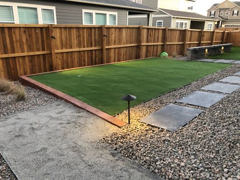 #Dogfriendly landscape design for a small backyard. We used a mixture of small gravel and small river rock to reduce problematic digging areas and create a dog run space with turf grass and low voltage outdoor lighting. Wooden privacy fencing eliminates the chance of your four-legged friend escaping during play time. 

Some dog friendly designs will incorporate trees, plants, or shrubs, but we consider your dog's individual habits when designing the best oasis for you and them to share. Large Dog Backyard Ideas, Dog Paths In Backyard, Turf And Rock Landscape, Outdoor Dog Area Play Spaces, Turf Backyard Ideas Play Areas, Dog Friendly Backyard Landscaping Design, Small Patch Of Grass In Backyard, No Grass Backyard Ideas For Dogs, No Grass Backyard Ideas On A Budget Dog Friendly