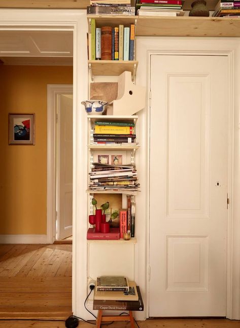 A Cozy Swedish Apartment Filled with Charm 9 Books Around Doorway, Book Shelf Small Apartment, Diy Wooden Shelves Living Room, Swedish Apartment Decor, Office Book Nook, Small House Book Storage, Bookshelf Above Door, Simple Aesthetic Rooms, Apartment Shelving Ideas