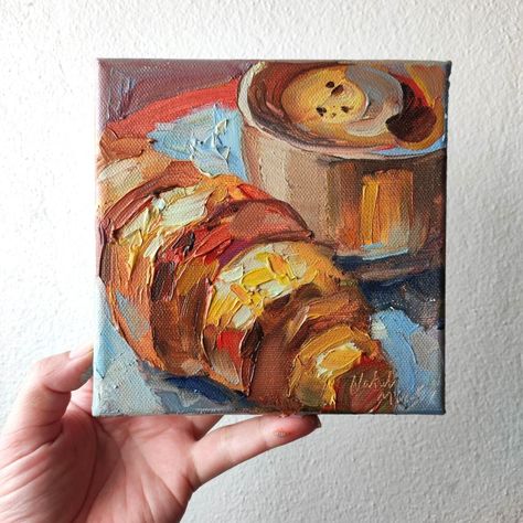 Oil painting on stretched canvas - "Coffee and croissant".  Original painting, not print.  Size: 6x6 inches.  Artist: Natali Miasnikova. Instagram: @MountainFogArt. The painting is signed by the artist.  When sending the painting will be carefully packed.  There are many more interesting paintings in my gallery.  Welcome! Croissant Painting, Cafe Painting, Interesting Paintings, Food Paintings, Art Mini Toile, Food Art Painting, Painting Gifts, Wall Art Coffee, Art Mignon