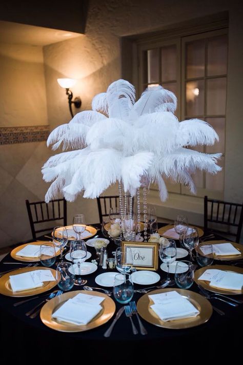 Ostrich feather centerpiece for Great Gatsby wedding Great Gatsby Party Centerpieces, 1920s Centerpieces, Gold Feather Centerpiece, Great Gatsby Centerpiece, Feather And Pearl Centerpieces, Feather Table Centerpieces, Ostrich Feather Decor, Feather Centerpiece Wedding Gatsby, Black Ostrich Feather Centerpiece