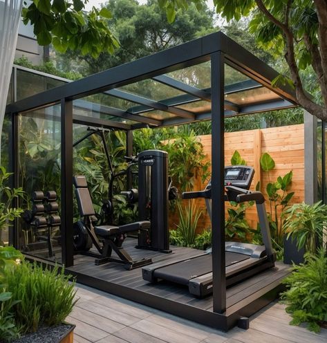 Experience the perfect blend of nature and fitness with this modern outdoor gym! Set in a lush garden, this sleek gym features a glass roof and black metal frame, equipped with top-of-the-line fitness gear including a treadmill, weight bench, and a multifunctional training machine. Surrounded by vibrant greenery, this serene and invigorating space is ideal for those who love to...#Training #Building #and #Muscle #Fitness #NutritionTips #Enhancing #Strength #HealthyLiving #HealthTips #SelfCare Outdoor Gyms Ideas, Gym In Garden, Outside Gym Ideas, Garden Shed Gym, Outside Home Gym, Gym At Home Design, Home Gym Shed Ideas, Outside Gym Ideas Backyards, Gym Shed Backyard