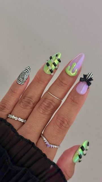 Daily Charme Official on Instagram: "Beetlejuice inspired nails but make it glazed & glow in the dark 💚🖤💜 Comment "BEETLEJUICE" for everything you need to create this look!   Save and share for inspo! ✨💅  #halloweennails #glowinthedarknails #beetlejuicenails #glazednails #spookynails #fallnails #diynails #nailtutorial #nailtrends #nailart  #nailinspo #halloweennails2024 #halloween2024" Halloween It Nails, Nailinspo Nailart, Nail Art For Halloween, Subtronics Nails, Exorcist Nails, Halloween Beetlejuice Nails, Halloween Nails Unique, Lydia Deetz Nails, Beetle Juice Nails Designs