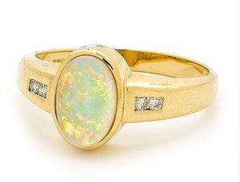 An elegant Solid Opal Gold Ring.  The Master Goldsmiths from Opals Australia have selected a beautiful Australian Solid Light Opal sourced from quality opal mines in the Coober Pedy region in South Australia. Setting is a simple bezel with channel set round brilliant cut diamonds on each side, smart and set with 18k yellow gold.   A traditional ring design, the opal is fantastic colour and is set in a stylish setting. #opalsaustralia Opal Australia, Jewellery Aesthetic, Magnificent Jewels, Mineral Jewelry, Opal Ring Gold, Art Nouveau Jewelry, Fabulous Jewelry, Opal Ring, Gems And Minerals