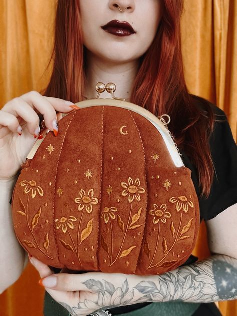 This stylish pumpkin inspired purse features a beautiful embroidery pattern of stars, moons, and flowers. Features a vintage style kiss lock clasp. Great for witchy fashion. #whimsigoth #witchyfashion #alternativefashion #purses #vintagefashion #embroidery #cottagecore Kiss Clasp Purse, Kiss Clasp Purse Pattern, Witchy Sewing Patterns, Embroidery Witchy, Witchy Sewing, Cottagecore Goth Aesthetic, Little Embroidery Ideas, Pumpkin Accessories, Cottagecore Purse