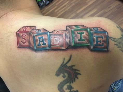 Toy Blocks name tattoo by Mike Hepler Block Name Tattoo, Kids Name Tattoo Ideas, Kids Name Tattoo, Sentimental Tattoos, Father Son Tattoo, Birthdate Tattoo, Name Tattoo Ideas, Tattoo Baby, Biblical Tattoos