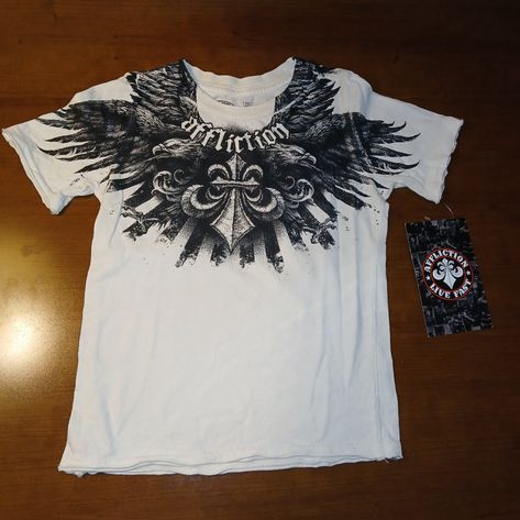 Nwt Affliction Venturous Toddler T-Shirt In White. Short Sleeve Ribbed Crew Neck Extremely Rare Black Graphic Print Raw Edges 100% Cotton Made In Usa Pit To Pit Measures 13" Length Measures 17" White Affliction Shirt, Cheap Alt Clothes, 2000s Fashion Shirts, Affliction Clothing Mens, Y2k Cross Shirt, Soft Affliction, Affliction Outfits, Tiktok Clothes, Y2k Graphics