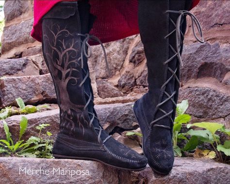 These Front Lace Knee High Boots are made by the brand Minnetonka; I free-hand etched a Norse compass Vegvísir on the toes, and Yggdrasil tree of life on the sides! This shoe features soft suede leather, a padded insole, and a durable but lightweight rubber sole.  Fit: True to size  Size 4 Women's available upon request Women's measurements: Height: 16.5 inches Calf Circumference measured at the top:      Minimum circumference : 14 inches (laces pulled tight)      Maximum circumference: 20 inche Womens Viking Boots, Viking Boots Woman, Skyrim Boots, Unique Boots For Women, Celestial Cottagecore, Viking Boots, Lace Knee High Boots, Medieval Boots, Viking Cosplay