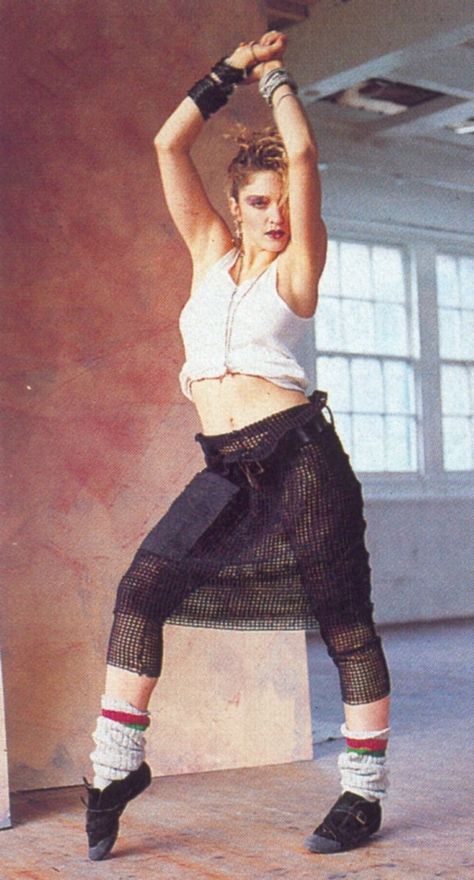 Madonna in her dance inspired outfit complete with netted skirt, leg warmers, half shirt, stacks of bracelets, and jazz shoes. 80s Leg Warmers, Madonna Young, Madonna Fashion, Madonna Looks, Madonna 80s, Madonna Photos, 80’s Fashion, 80s Outfit, 1990s Fashion