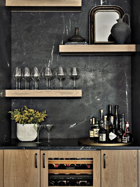 Off the kitchen and across from the dining area, a bar features Negresco granite from Serrano’s Marble & Granite in a leathered finish. The white oak cabinetry and floating shelves are the work of Modern Kitchen Center. The wine refrigerator is Sub-Zero. Negresco Granite, Rh Dining, Modern Oak Kitchen, Contemporary Mountain Home, Dallas House, Leather Granite, Modern Basement, Luxury Bar, Fun House