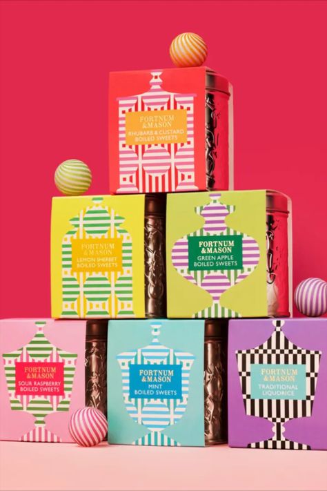 Together Design's packaging for Fortnum & Mason's pick-up gift range of sweets draws inspiration from the 18th-century sweets counter in the department store. The packaging showcases an array of vintage sweet jar shapes decorated with cheerful patterns and colors, paying homage to the timeless sweets category. Packaging With Pattern, Xmas Packaging Design, Cpg Packaging Design, Valentine Packaging Design Boxes, Colorful Packaging Design, Jar Shapes, Christmas Gift Box Template, Holiday Packaging Design, Christmas Packaging Design