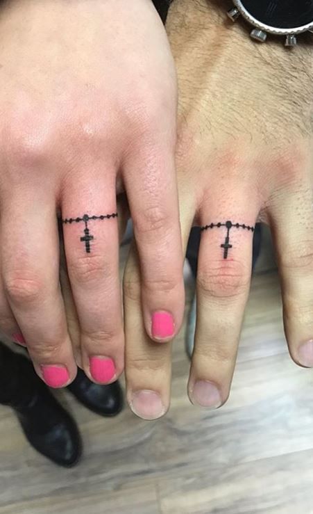 100 Unique Wedding Ring Tattoos You’ll Need to See - Tattoo Me Now Cross Wedding Ring Tattoo, Marriage Tattoos Ring Finger Unique, Female Wedding Ring Tattoo, Cross Ring Tattoo, Ring Tattoos For Couples Marriage, Ring Tattoo Designs Wedding, Tattoo Rings Wedding, Ring Tattoo Designs For Women, Marriage Tattoos Ring Finger