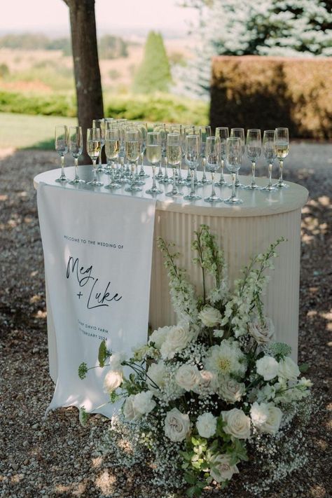 What a dreamy setup! 1 metre linen welcome sign used as the most gorgeous drinks station at @campdavidfarm 🫶🏼 _____________________ info@ateliercreativeau.com ateliercreativeau.com * * * #customsignage #weddinginvites #weddinginvitationideas #weddingflowers #weddingdesign #weddingstylist #weddingflowersau #customdesign #luxewedding #bespokeflorals #weddingdaydetails #weddingsignage #weddingstationery #eventflorals #floraldesigner #weddingcreative #invitations #weddingstationer #floraldesign... Ceremony Welcome Drinks, Wedding Welcome Champagne, Wedding Drink Table Ideas, Drinks Reception Wedding, Champagne Welcome Table, Welcome Champagne Wedding, Water Station Wedding, Welcome Drink Ideas, Wedding Bar Decorations