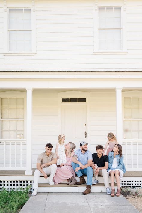 large family laughing together on the front porch Front Porch Portraits, Family Photo In Front Of House, Porch Family Photoshoot, Front Porch Family Pictures, Front Porch Pictures Family, Family Porch Photos, Family Laughing Together, Porch Family Photos, Front Porch Family Photos