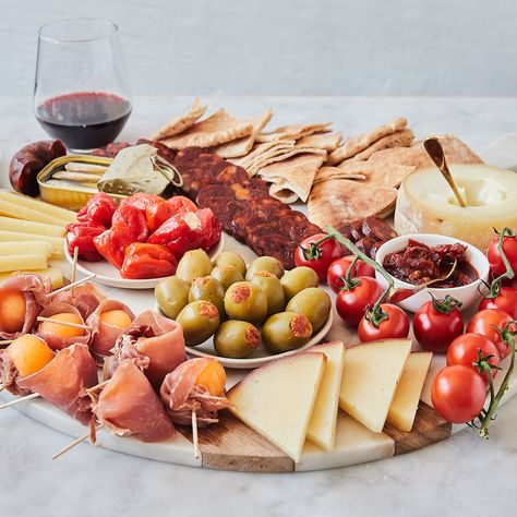 We’re taking a trip to Spain with this DIY tapas-inspired board. A cheese and charcuterie platter that takes snacking to the next level, incorporating some of the best of Spanish and Portuguese flavor onto one party-ready spread. We’ve chosen three incredible cheeses, from approachable Manchego to bold Amanteigado Grande, and paired them with classic chorizo and jamon, as well as sardines. Plus, a selection of sweet, salty, and delectable sides like stuffed peppers and olives, chutney, and ... Portuguese Charcuterie Board, Diy Tapas, Tapas Board, Cheeseboard Recipe, Tapas Party, Trip To Spain, Party Hosting, Cheese Stuffed Peppers, Holiday Tips