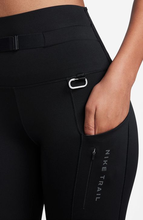 A high waist helps reduce rolling, pinching and sliding in trail-ready leggings made with Dri-FIT technology that keeps you cool and comfy. A detachable ripstop side pack and small carabiner allow you to carry all essentials so you're ready for any adventure. 25" inseam; 8" leg opening; 10" front rise; 13" back rise (size medium) Dri-FIT moisture-wicking technology Side drop-in pockets; side hidden-zip pocket; three back waist drop-in pockets Detachable zip side pack Reflective details enhance visibility in low light or at night 80% polyester, 20% spandex with 100% polyester gusset Machine wash, dry flat Imported Women Trail Running, Workout Clothes Black Women, Running Accessories For Women, Gym Fashion Women, Fitness Fashion Active Wear, Chic Activewear, Fitness Activewear, Running Accessories, Gym Fits