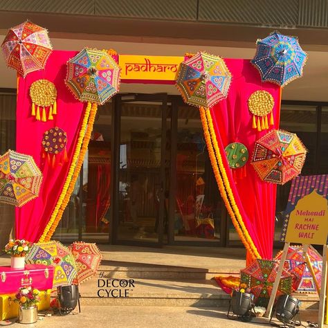 Entrance for Traditional and quirky Mehendi Decor with umbrellas and flowers. Colorblocking decor.

#colorfuldecor#mehendi#mehendidecor#mehendiideas#indianwedding#weddingdecor#weddingdecoration#mehendidecor#weddingdesign#thedecorcycle Dandiya Night Decoration For Navratri, Rajasthani Haldi Decor, Shadi Decoration Indian Weddings, Mayra Decoration, Entrance Decor For Wedding, Mehendi Entrance Decor, Rajasthani Theme Decoration, Garba Decoration Ideas Navratri, Indian Wedding Entrance Decor