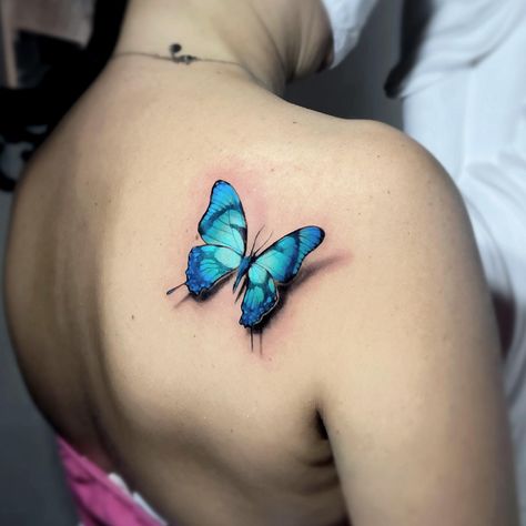 30 Awesome Blue Butterfly Tattoo Ideas for 2024 Light Blue Butterfly Tattoo, Blue Morpho Butterfly Tattoo, Butterfly Tattoo Ideas, 3d Butterfly Tattoo, Blue Butterfly Tattoo, X Tattoo, Blue Morpho Butterfly, Thai Tattoo, Morpho Butterfly