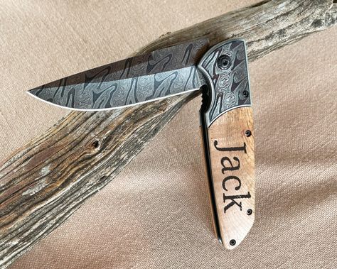 This is a Hand crafted, in house, Laser engraved pocket knife. The perfect gift for a father, expecting father, groomsman and more. The knife is 8 inches open, with an olive wood handle and fiber laser engraved printed blade with an oil design which can be used for camping, fishing and other activities. We can engrave initials, a name or up to two small sentences & a name. This is customizable, Please let me know if you have any questions. Engraved Pocket Knives, Engraved Knife, Engraved Initials, Camping Items, Father Gift, Custom Knife, Groomsmen Gift, Gift For Husband, Olive Wood